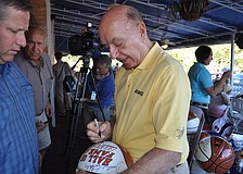 Dick Vitale signs a basketball for Alan Streitmatter.