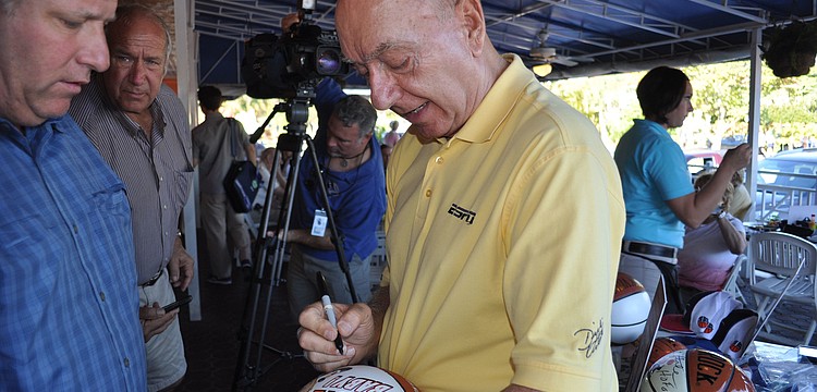 Dick Vitale signs a basketball for Alan Streitmatter.