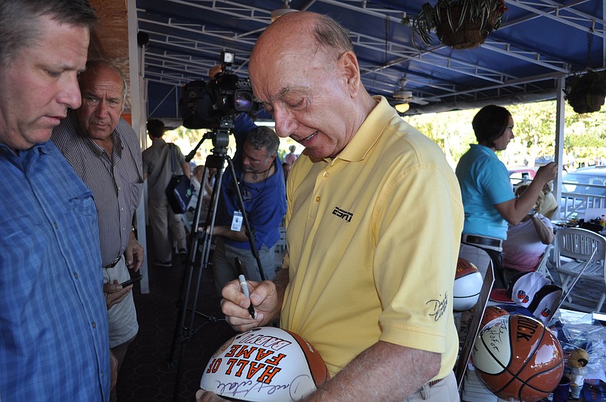 Dick Vitale signs a basketball for Alan Streitmatter.
