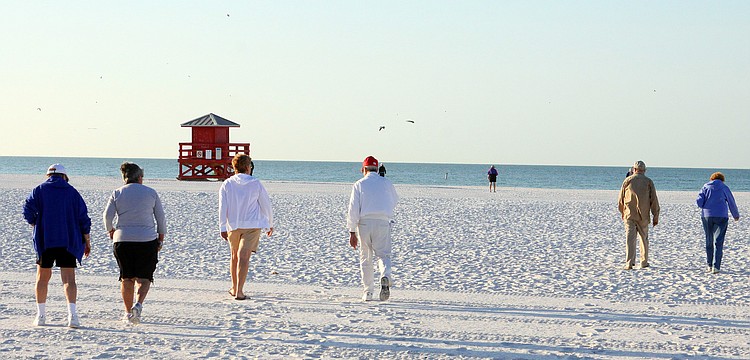 Walkers make their way down to the shore to participate in the Senior Beach Walk, Wednesday, Feb. 1, on Siesta Key Beach.