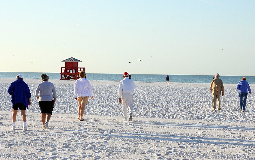Walkers make their way down to the shore to participate in the Senior Beach Walk, Wednesday, Feb. 1, on Siesta Key Beach.