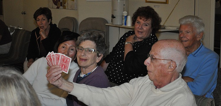 The audience looks bewildered that Chandler could guess all of the cards in the hand