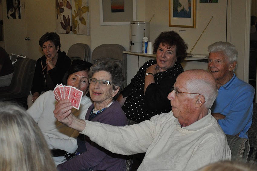 The audience looks bewildered that Chandler could guess all of the cards in the hand