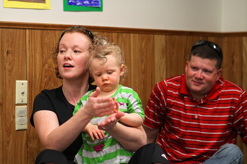 Brian Moran watches as his wife, Erin, does the sign for â€œcakeâ€ and their daughter, Aura, 19 mos., tries to imitate.
