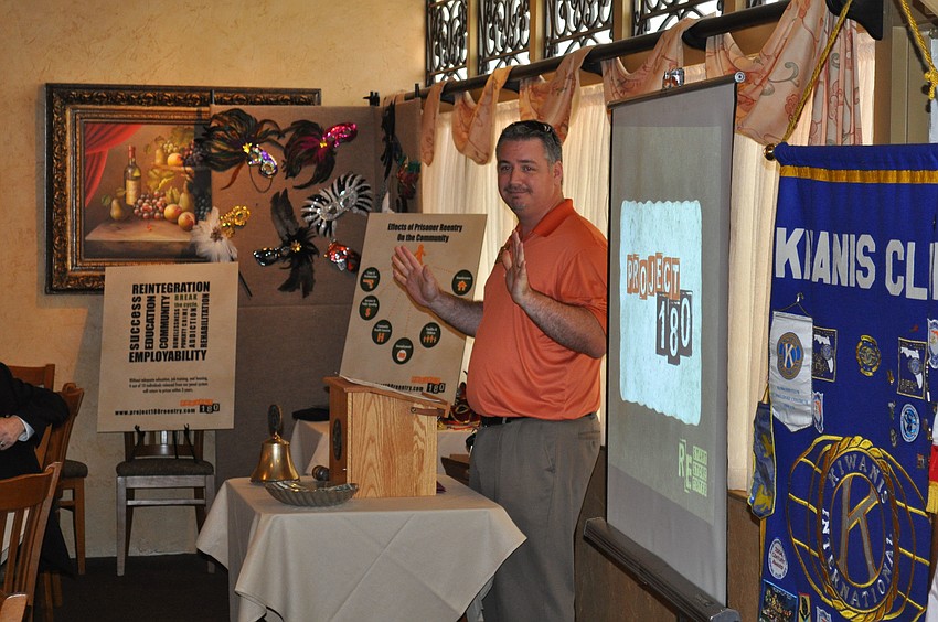 Matthew Anderson delivers a joke to the meeting.