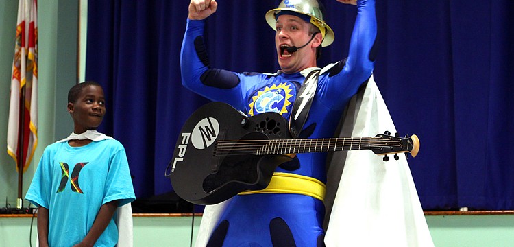 Captain Conservation shows off his superhero pose as Jordon King, 9, looks on, Wednesday, Feb. 8, at Bayhaven Elementary.