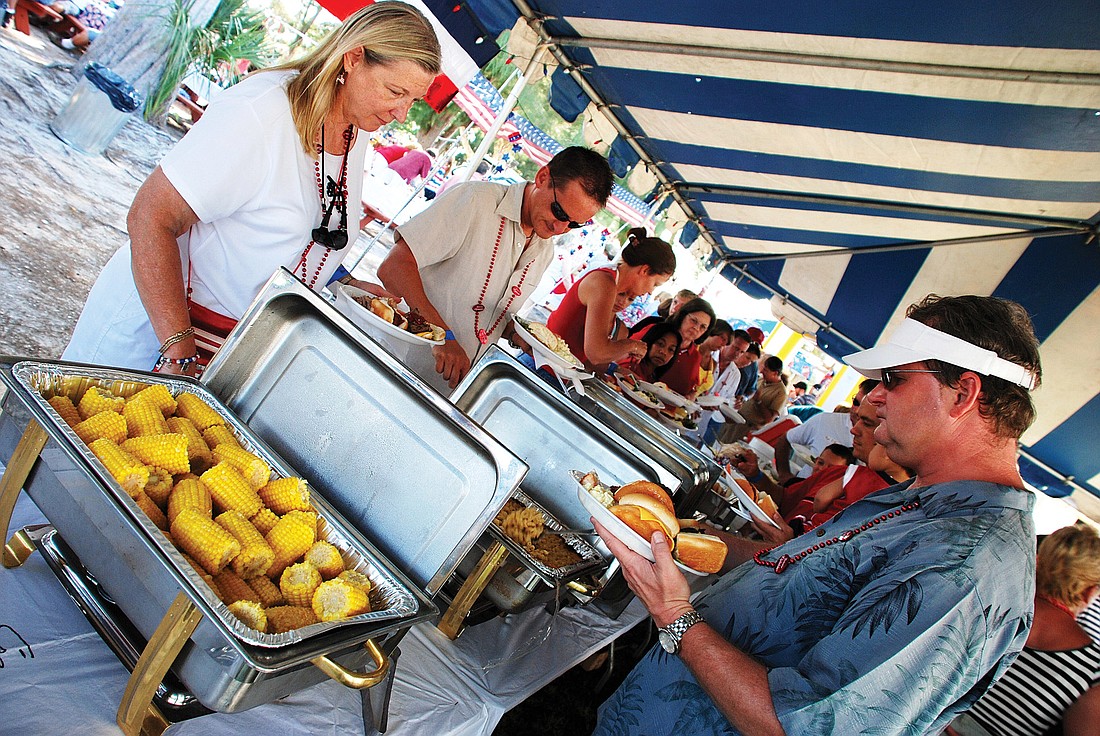 Siesta Chamber VIP picnickers enjoy a July Fourth feast. File photo.