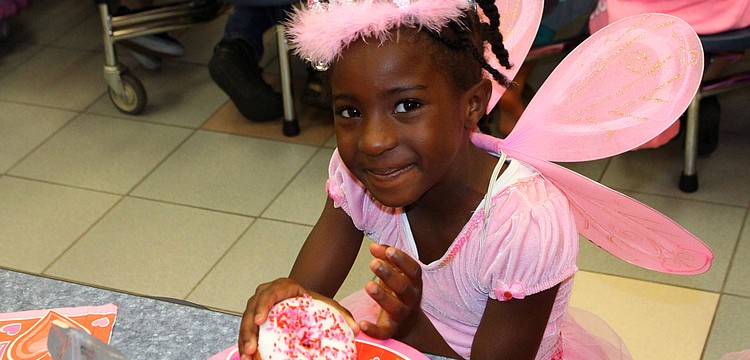 Dara Gray, 6, enjoys her donut during the breakfast that followed the Fairytale Parade.