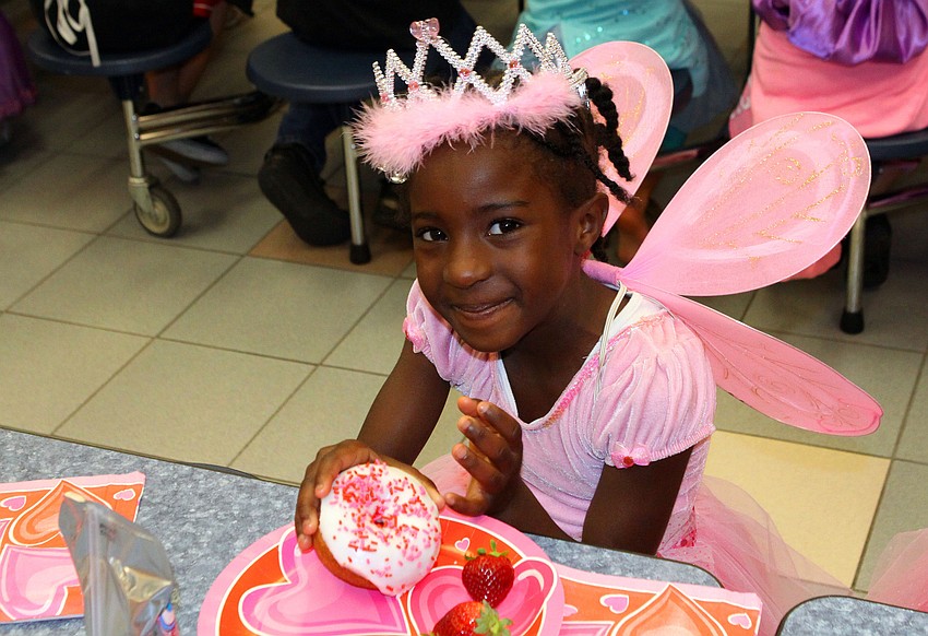 Dara Gray, 6, enjoys her donut during the breakfast that followed the Fairytale Parade.