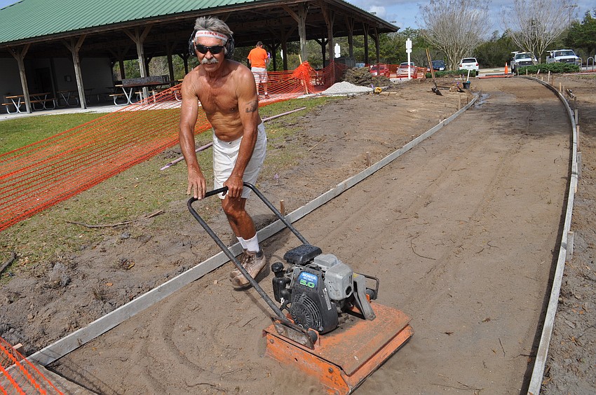 Workers currently are replacing portions of sidewalk at Greenbrook Adventure Park.