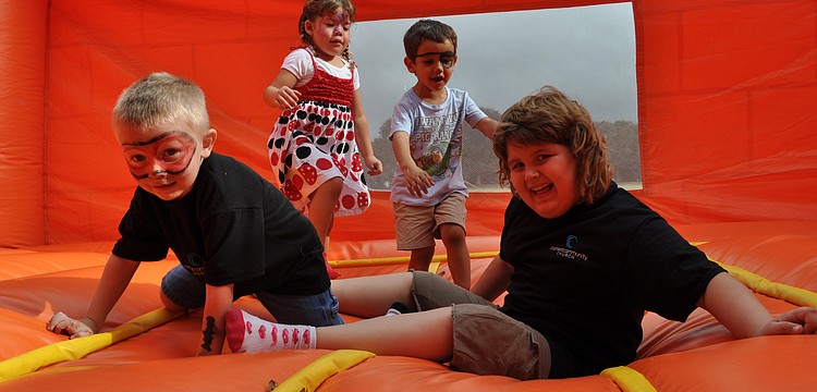 Sam Klein and Hannah Miller, front, enjoyed the bounce house with their friends.