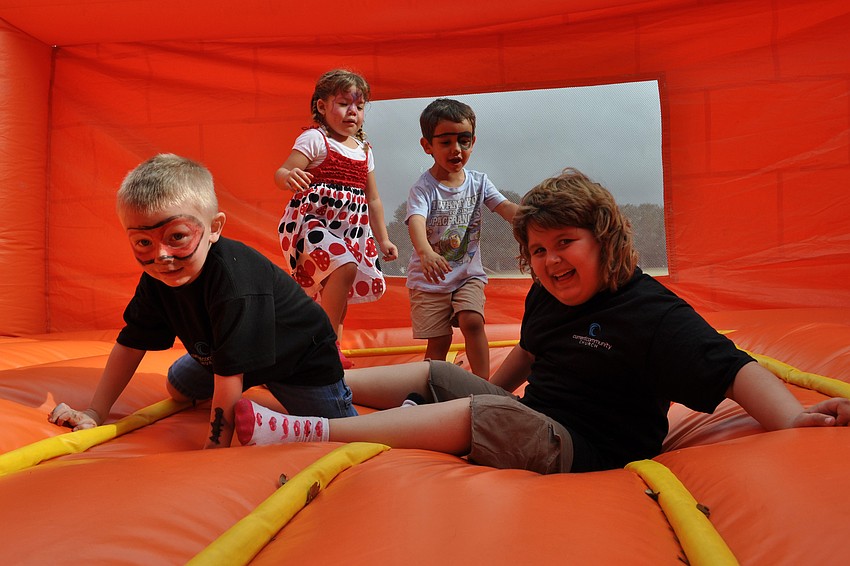 Sam Klein and Hannah Miller, front, enjoyed the bounce house with their friends.