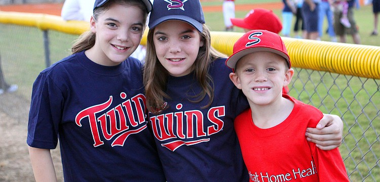Meagan and Heather, 12, with their brother, Craig Schwier, 8.