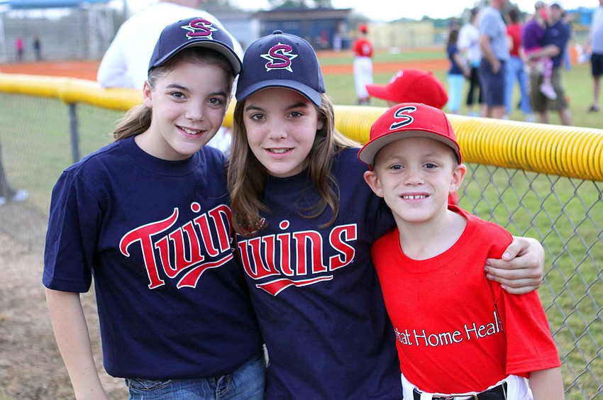 Meagan and Heather, 12, with their brother, Craig Schwier, 8.
