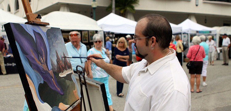 Alexander Snyder, an alumnus and teacher at Ringling College, paints during the 24th Annual Downtown Sarasota Art Festival, Sunday, Feb. 19.
