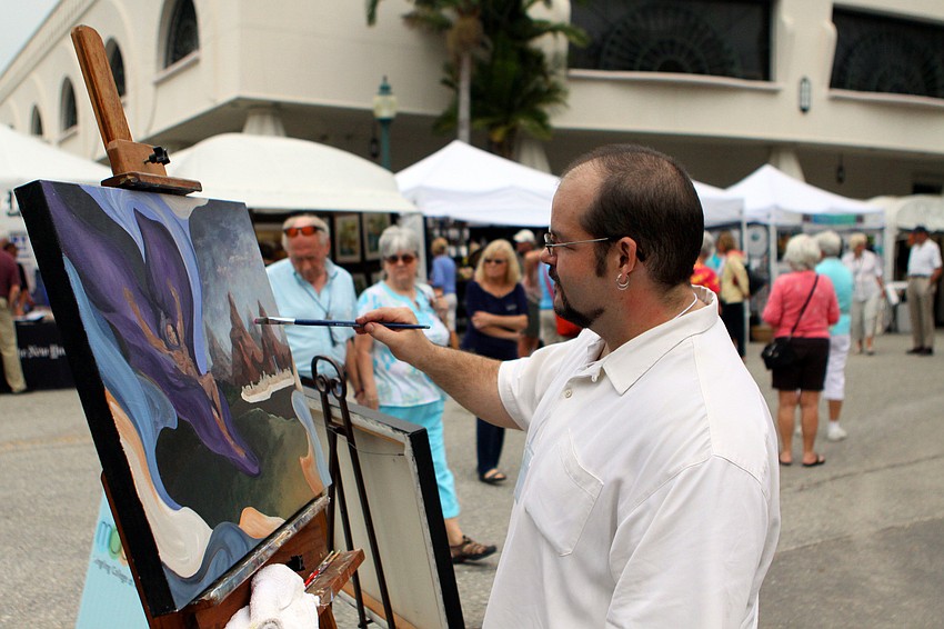Alexander Snyder, an alumnus and teacher at Ringling College, paints during the 24th Annual Downtown Sarasota Art Festival, Sunday, Feb. 19.