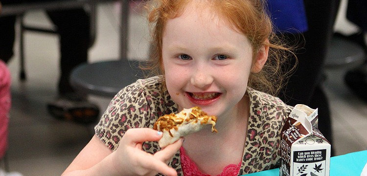 Abigail Schmitt, 6 1/2, enjoys her burrito, Thursday, Feb. 23, at El Restaurante Bay Haven.