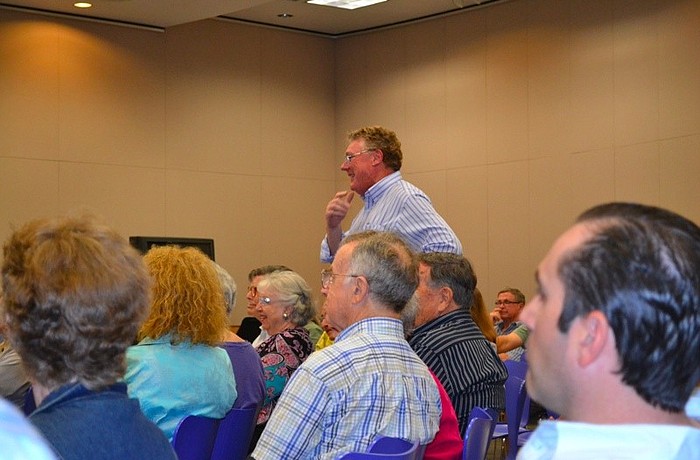 Commissioner Paul Caragiulo, bottom right, looks on as residents and merchants take their turn complaining about the parking meter program Thursday.