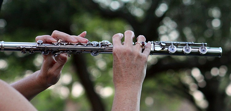 Betsy Hudson Traba plays the flute, Friday, March 2, during March's Sounds of the Soul service outside of Pine Shores Presbyterian Church.