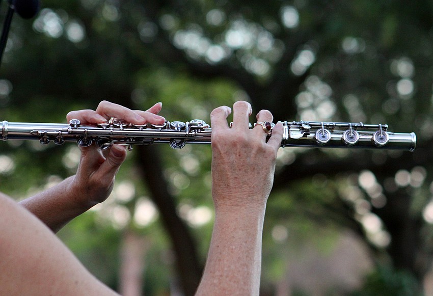 Betsy Hudson Traba plays the flute, Friday, March 2, during March's Sounds of the Soul service outside of Pine Shores Presbyterian Church.