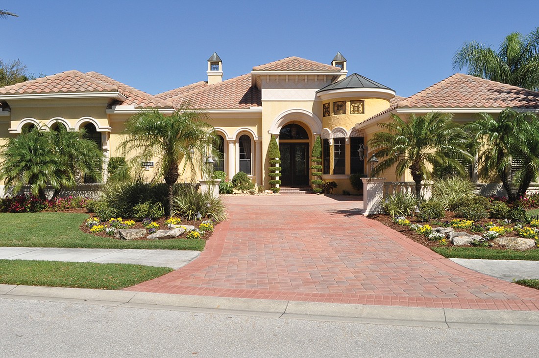 This Country Club of Lakewood Ranch home, which has four bedrooms, three-and-one-half baths, a pool and 4,304 square feet of living area, sold for $900,000. Photo by Jen Blanco.