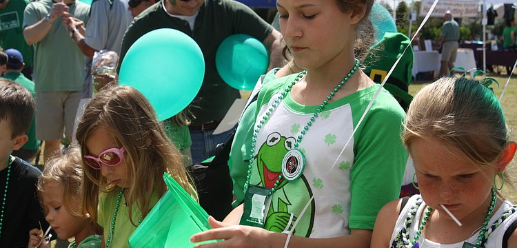 Children decorated green hats at the Observer booth.