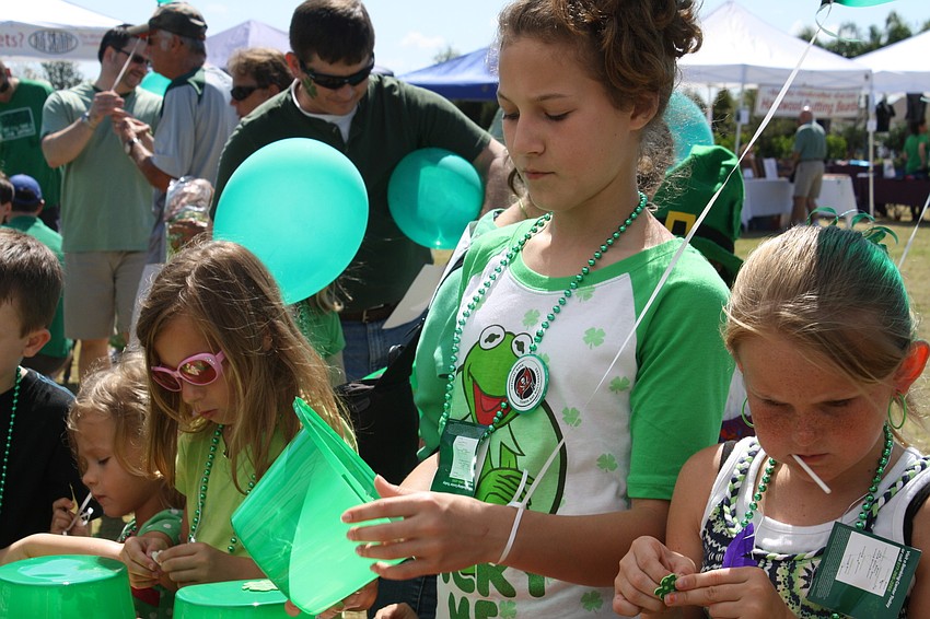 Children decorated green hats at the Observer booth.