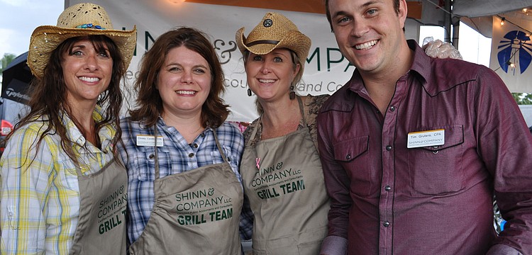 Jamie Phillips, Christy Cardillo, Kim Dalglish and Tim Gruters, of Shinn & Co., dished out food for guests.