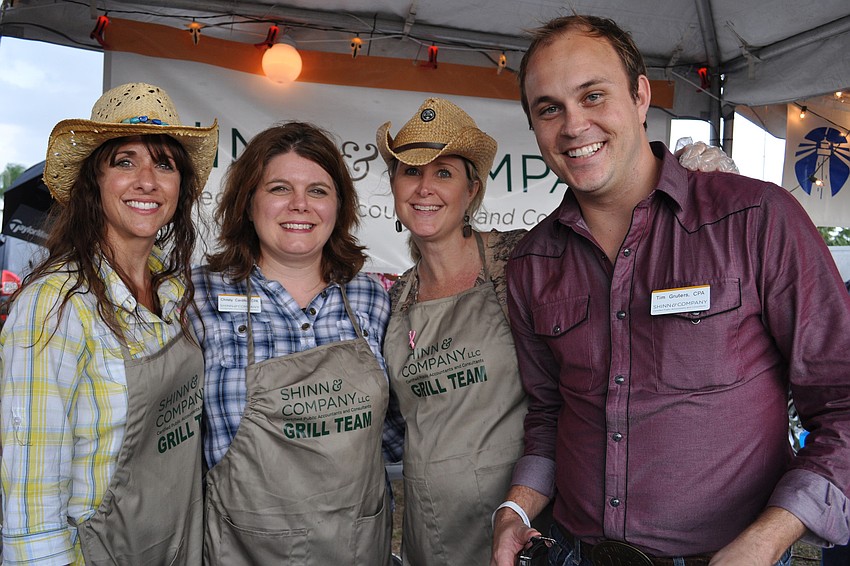 Jamie Phillips, Christy Cardillo, Kim Dalglish and Tim Gruters, of Shinn & Co., dished out food for guests.
