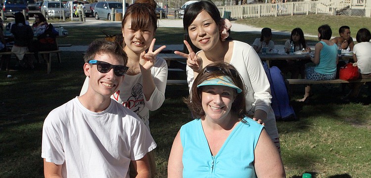 Mizui Asuka and Tomomi Yase give the peace sign while posing with Mason Bo and Lori Bo, Sunday, March 25, at the Kiltie and Green Band picnic.