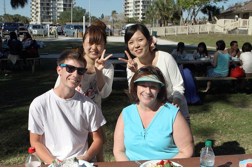 Mizui Asuka and Tomomi Yase give the peace sign while posing with Mason Bo and Lori Bo, Sunday, March 25, at the Kiltie and Green Band picnic.