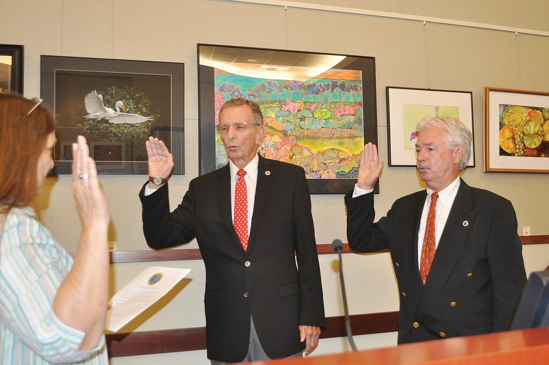 Town Clerk Trish Granger administers oaths of office Tuesday night to Vice Mayor David Brenner and Mayor Jim Brown. Photo by Dora Walters.