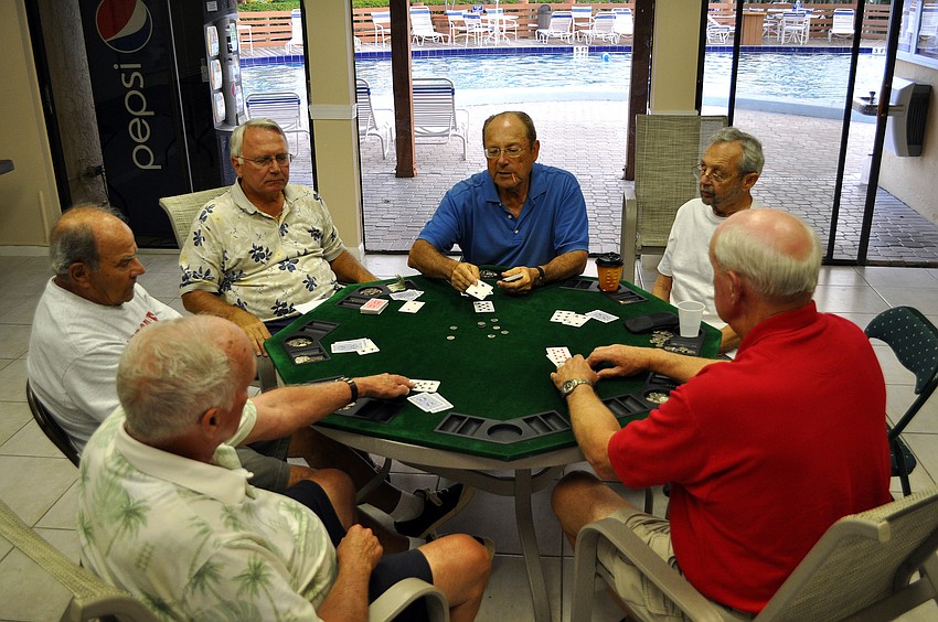 Pat Shiplett, Joe Figluizzi, Barry McElreath, George Magiet, Robert Kaemerer and Derek Noll sit around the poker table inside the clubhouse.