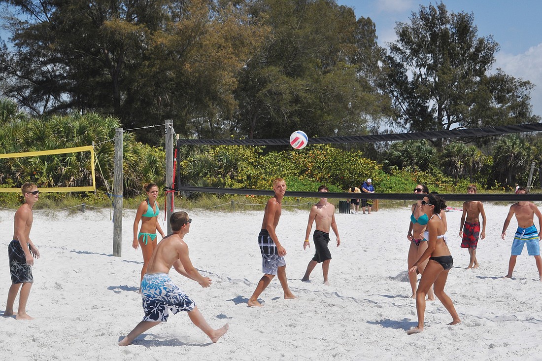 Spring breakers enjoy a game of volleyball Friday, March 23, on Siesta Key Beach.