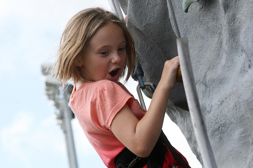 Rosemarie Lubben, 7, worked hard to make her way up the rock-climbing wall.