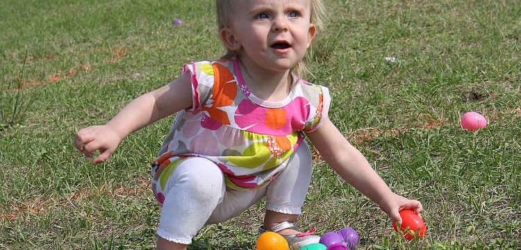 Alyssa Call, 15 months, had a blast gathering eggs at Harvest United Methodist Church.