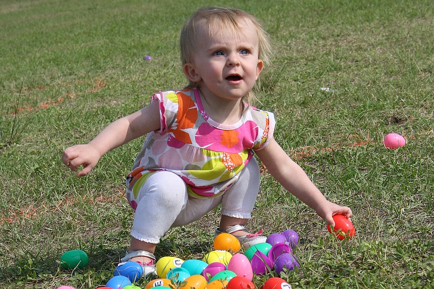 Alyssa Call, 15 months, had a blast gathering eggs at Harvest United Methodist Church.