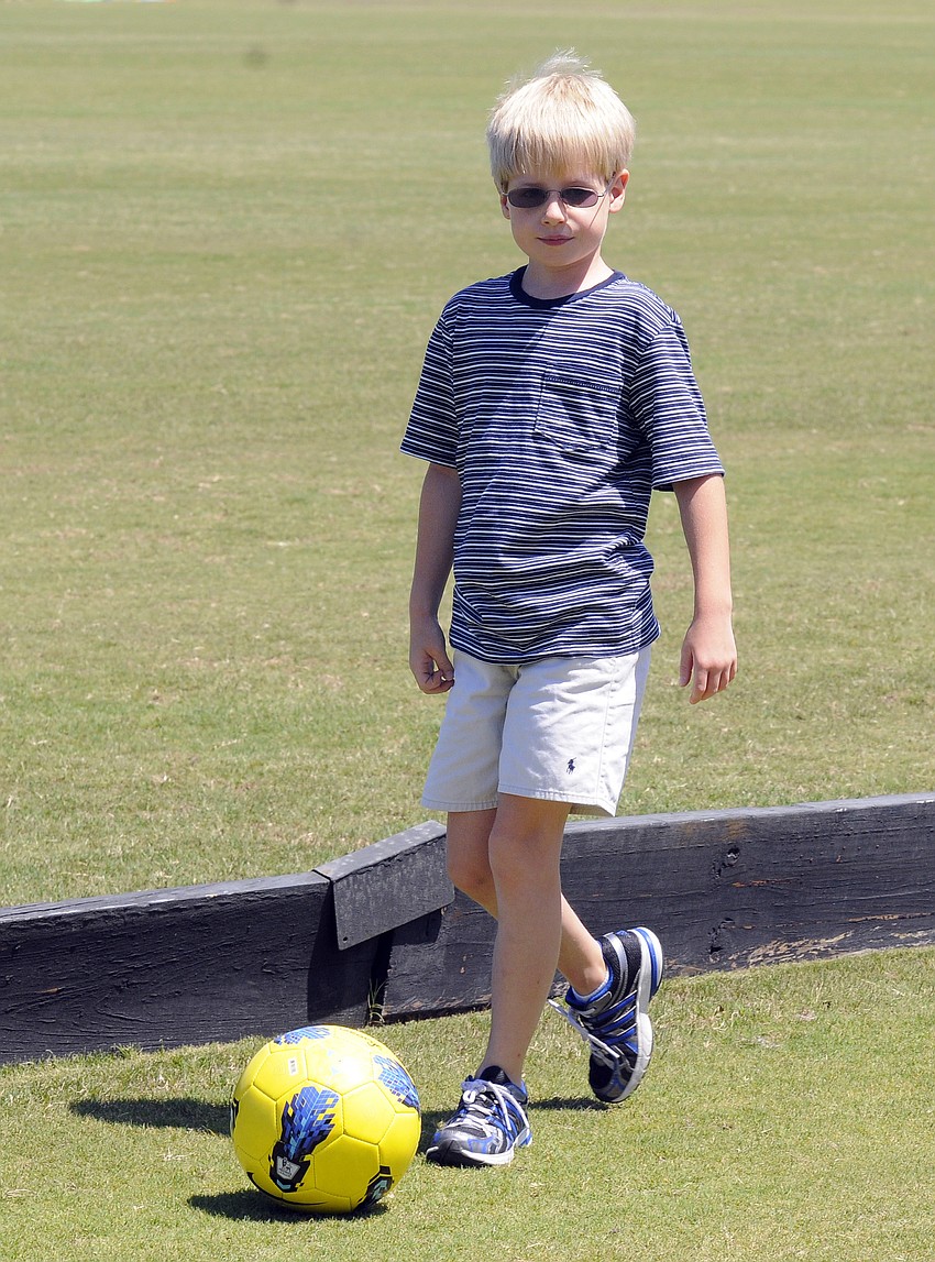 Seven-year-old George Oâ€™Brien played soccer while waiting for the polo match to begin.