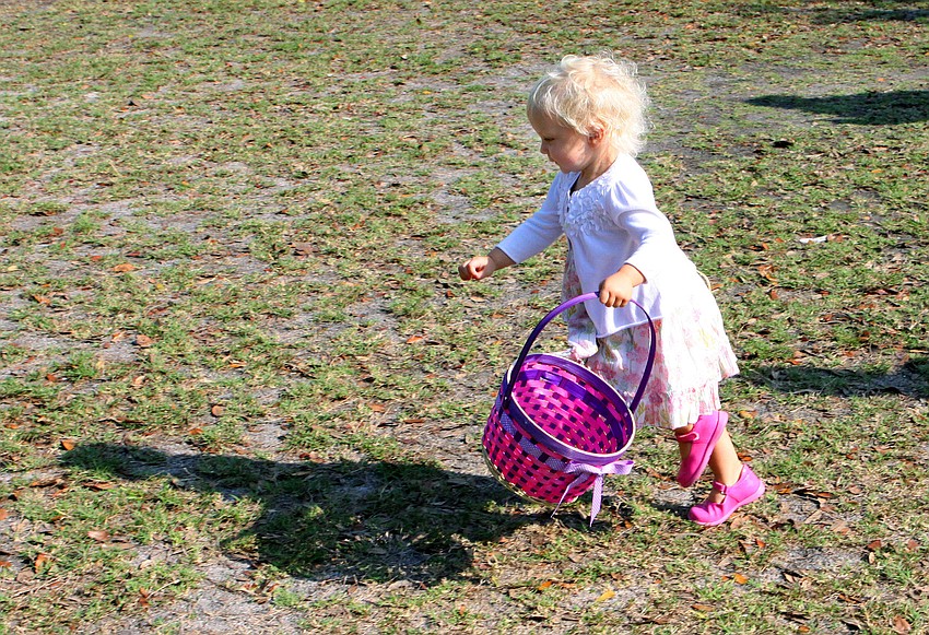 Mathilde Wesson, 2, was off and running to collect Easter eggs, Saturday, April 7, at St. Michael the Archangel.