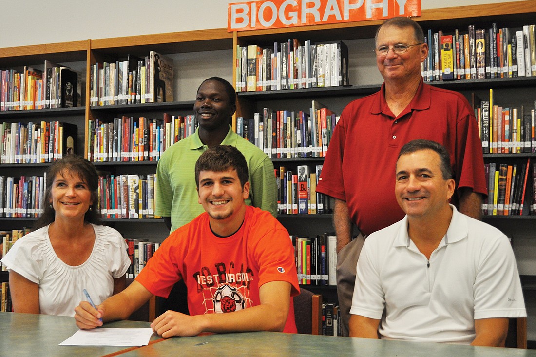 Tyler Marshall, center, became the first Pirate to sign a scholarship to play soccer in college.