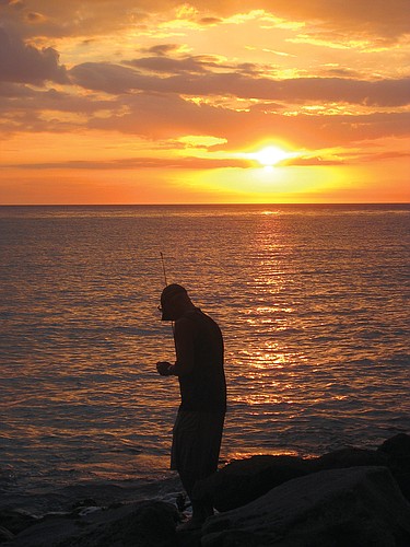 Eileen Weber took this photo of the sun setting over a fisherman on the South Jetty in Venice.