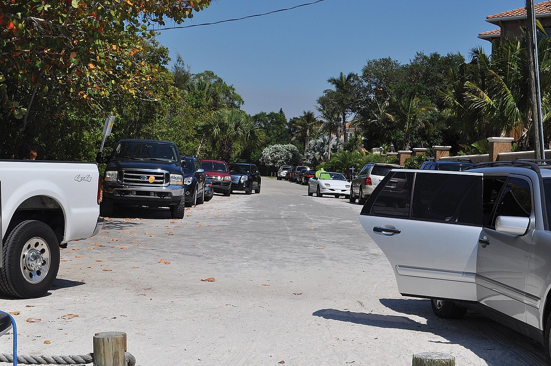 On busy days, cars crowd North Shell Road, making it difficut for residents to enter and leave their driveways.