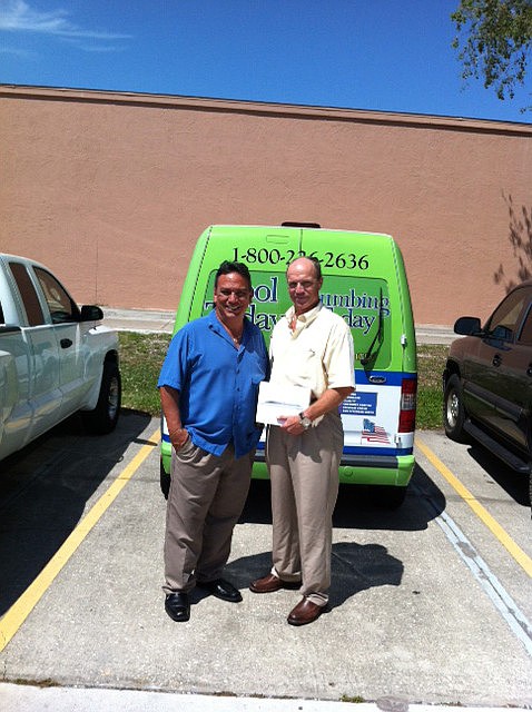 Cool Today's March photo weather winner David Johnson, left, accepts his Ipad from Jamie DiDomenico owner of Cool Today.