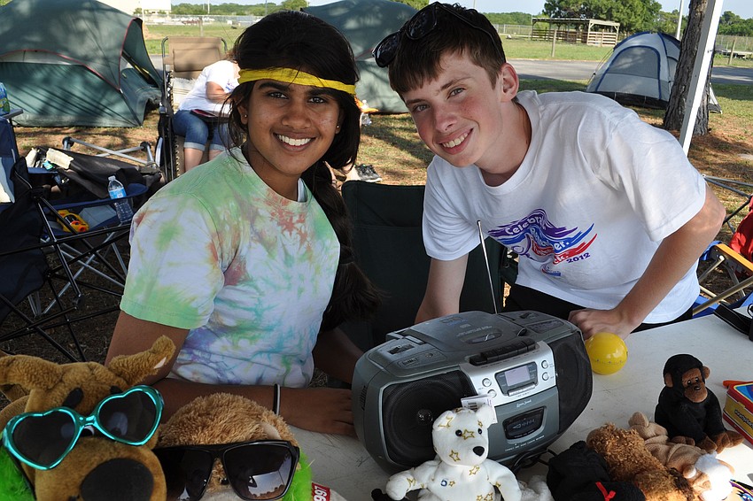 Mona Vachhani and Sean Shinham, of the Braden River High School Key Club,  had a tent themed '90s pop music.