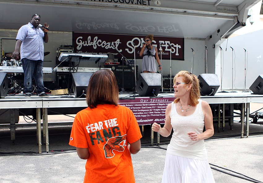 Adar Pitts and Donna Carey dance while Democracy performed on stage during EcoFest, Saturday, April 14.
