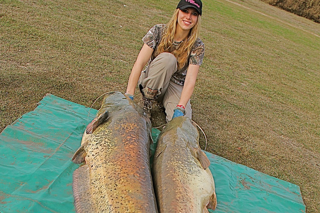 Larysa Switlyk shows off two wels catfish she caught in Spain. These are the same fish sheÃ¢â‚¬â„¢ll be fishing for in the World Catfish Classic in May. Courtesy photo.
