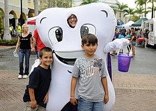 Six-year-old Andrew Boudreau and his older brother Matthew, 8, enjoyed a visit with Orthodontists of Lakewood Ranchâ€™s Super Tooth.