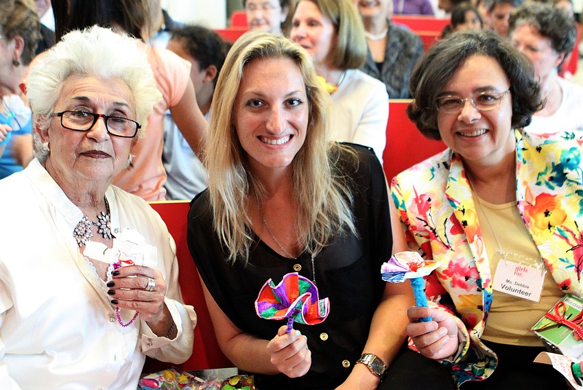 Juliette Beer, Emily Harris and Debbie Trice show off the flowers they got from Shabby Chic, one of the ventures at Girls Inc, during the Girls Inc Volunteer Appreciation Day ceremony, Thursday, April 19, at Girls Inc.