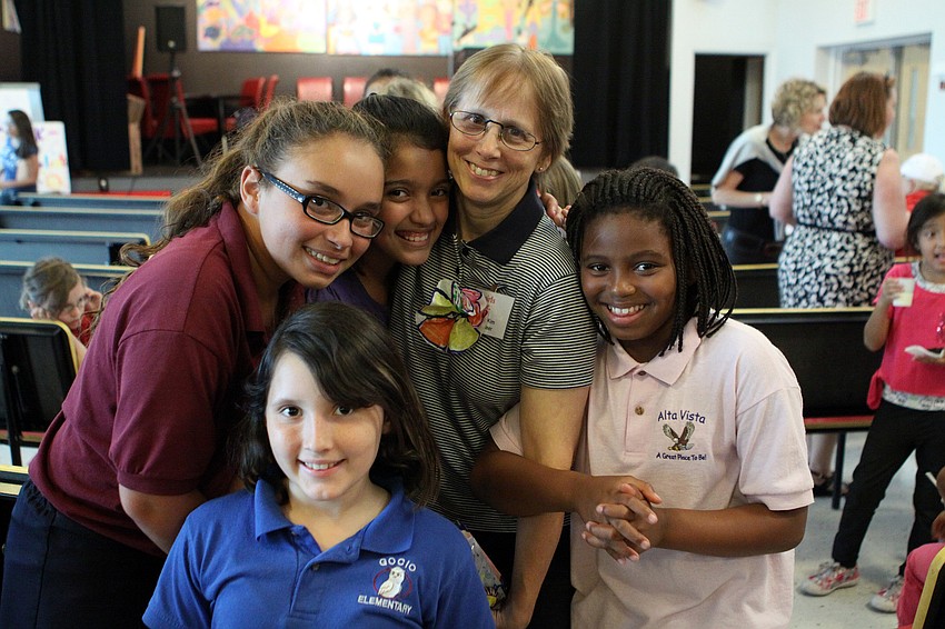 Volunteer Kim Anderson with Valentina Monroy, 9, Laurenette Castro, 11, Allison Zavala, 11, and Shaterria Smith, 10