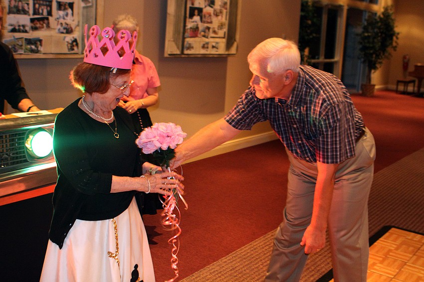 Earl Mehlenbacher presents the Queen of the Hop, Diane Hart, with her flowers.